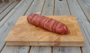 This is a fatty. At its most basic, a fatty is a roll of sausage meat, smoked. This one is wrapped in bacon and has baked beans running up the middle.